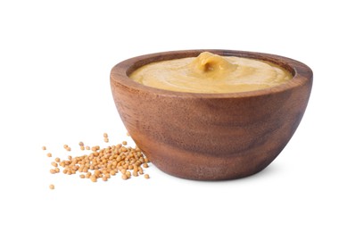 Fresh tasty mustard sauce in bowl and dry seeds isolated on white