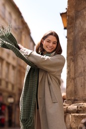 Photo of Beautiful woman in warm scarf on city street