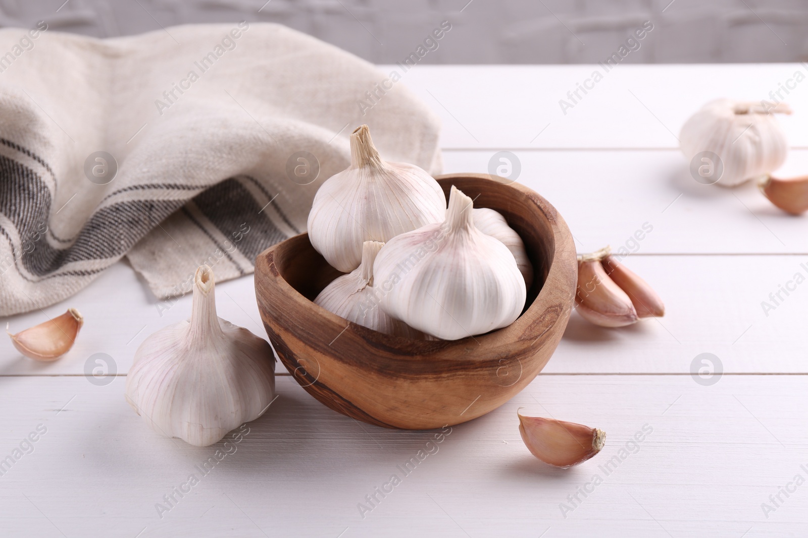 Photo of Fresh garlic on white wooden table, closeup