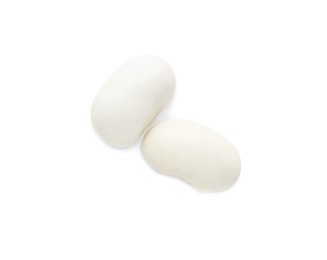 Photo of Two uncooked navy beans on white background, top view