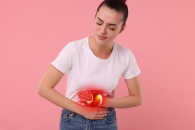 Woman suffering from abdominal pain on pink background. Illustration of unhealthy stomach