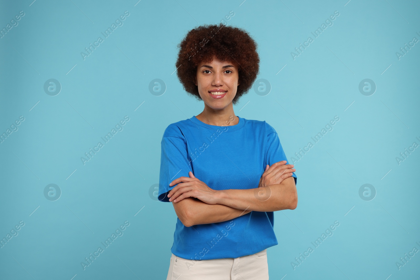 Photo of Portrait of happy young woman on light blue background