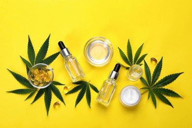 Photo of Flat lay composition with hemp leaves, CBD oil and THC tincture on yellow background