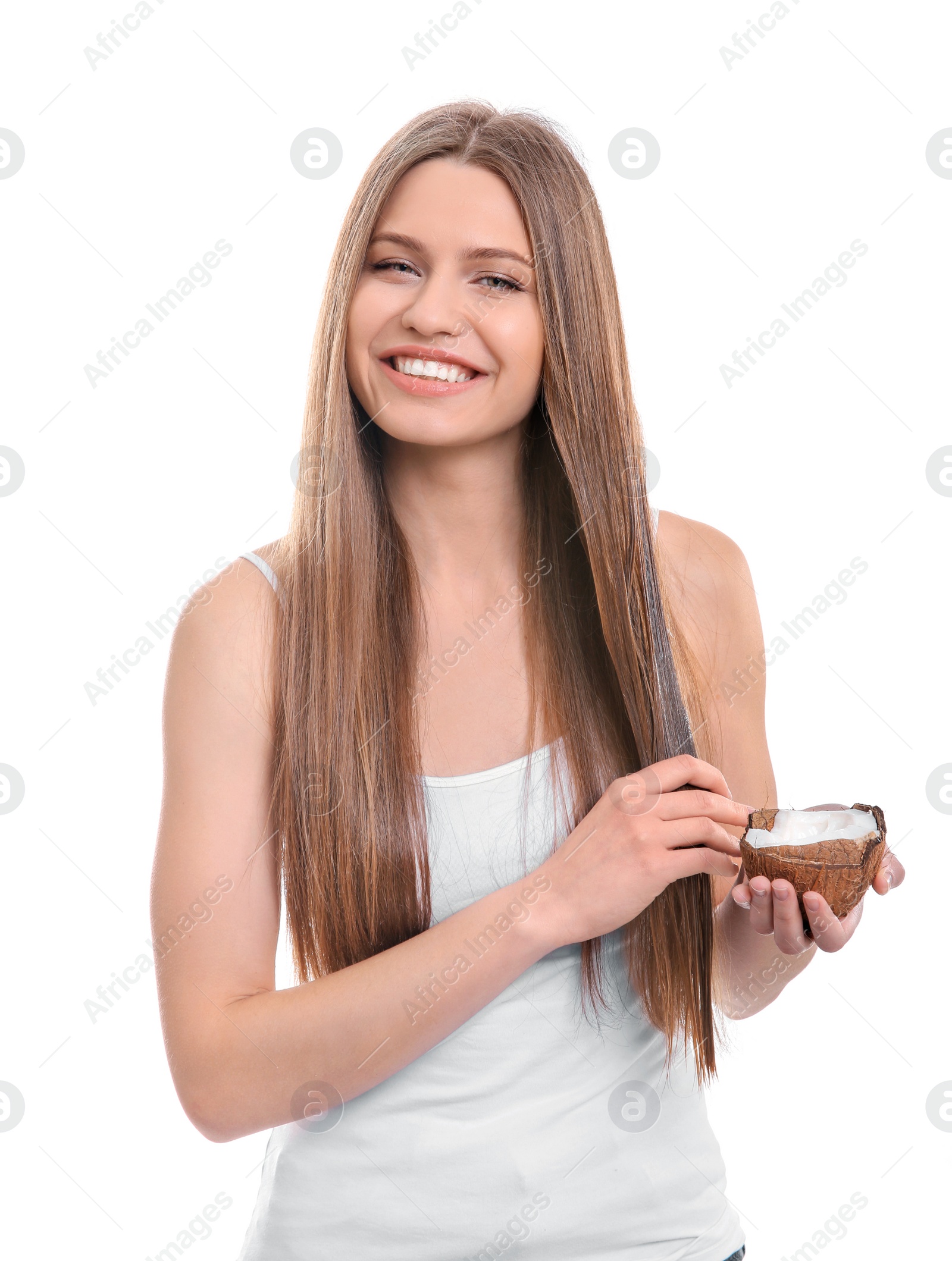 Photo of Young woman applying coconut oil onto hair against white background