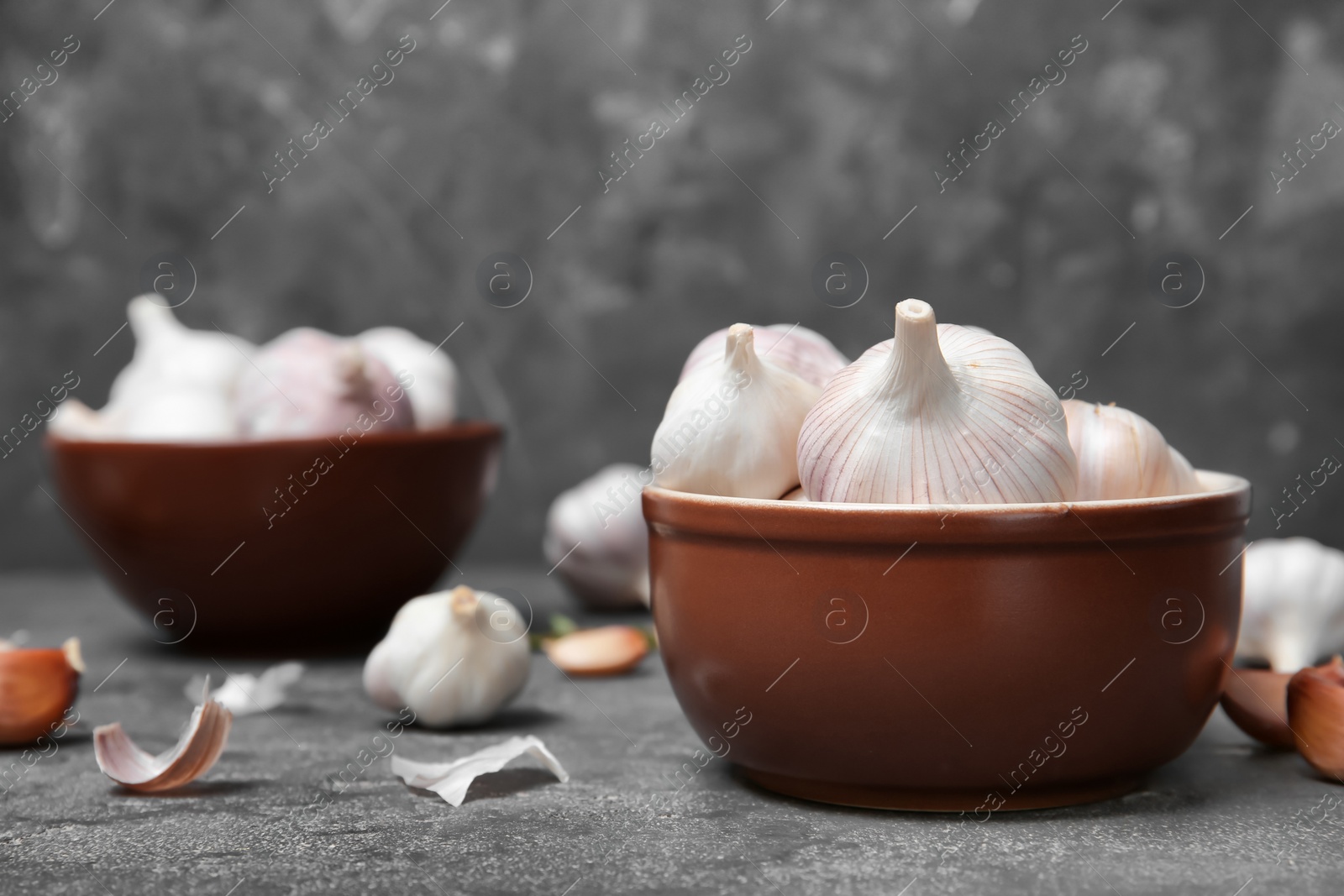 Photo of Bowl with fresh garlic bulbs on table. Organic food