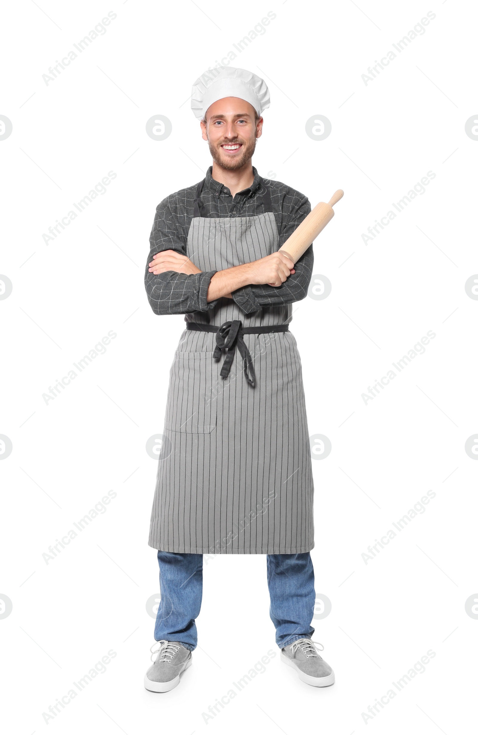 Photo of Professional chef holding rolling pin on white background