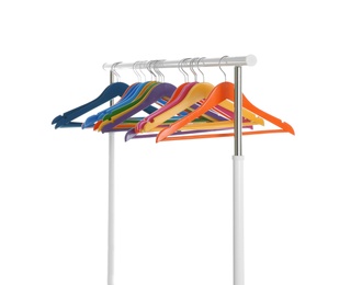 Photo of Wardrobe rack with different color hangers isolated on white