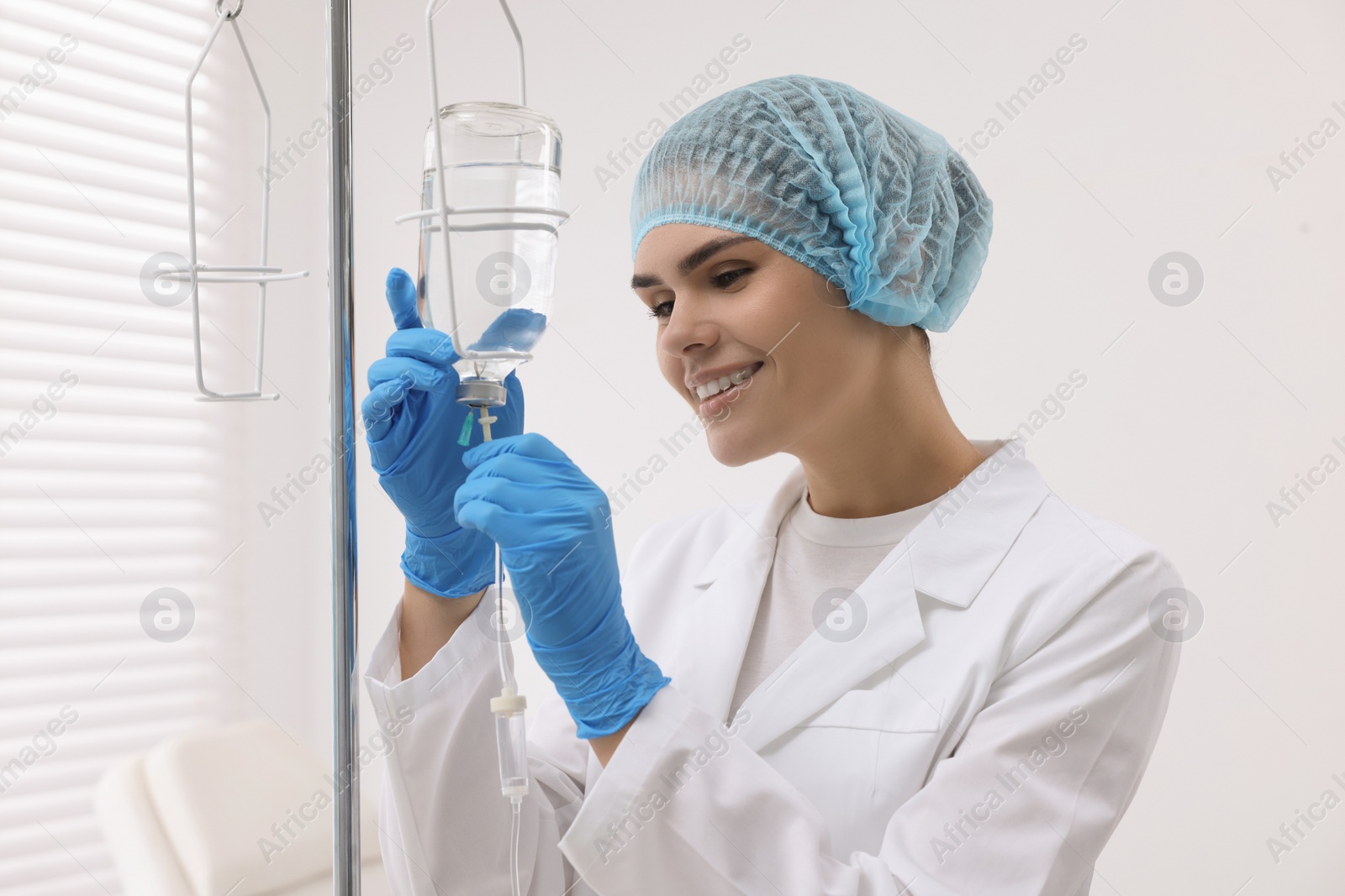 Photo of Nurse setting up IV drip in hospital