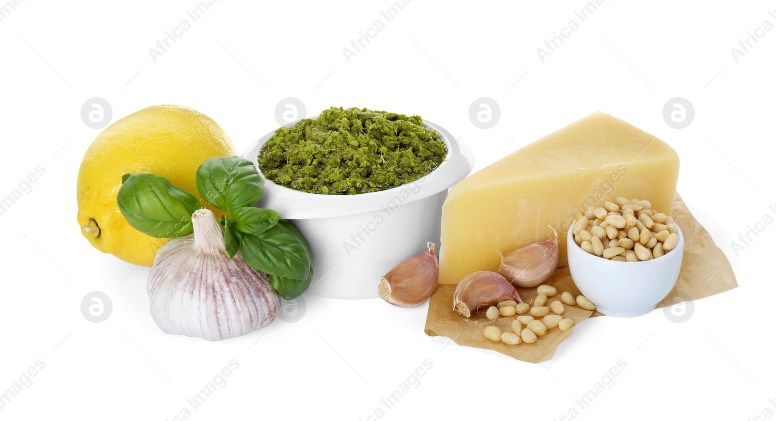 Photo of Delicious pesto sauce in bowl and ingredients isolated on white