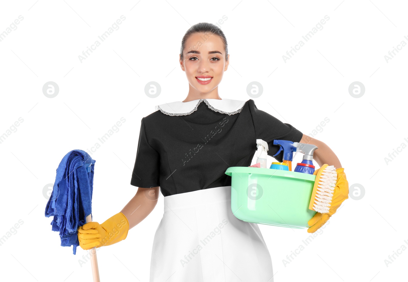 Photo of Young chambermaid holding mop and plastic basin with detergents on white background