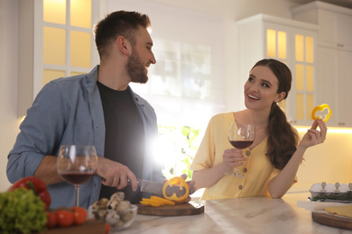 Photo of Lovely young couple cooking together in kitchen