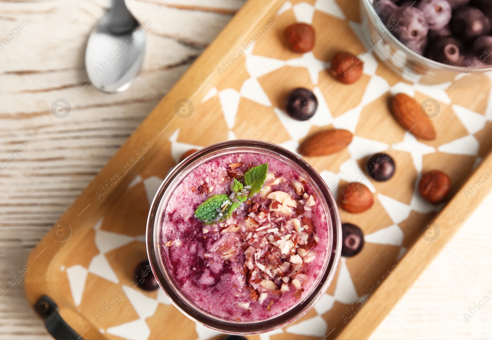 Photo of Flat lay composition with glass of delicious acai juice on wooden table