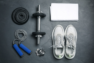 Photo of Gym equipment on black background, flat lay