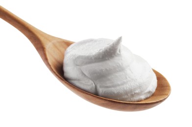 Photo of Wooden spoon with sour cream isolated on white