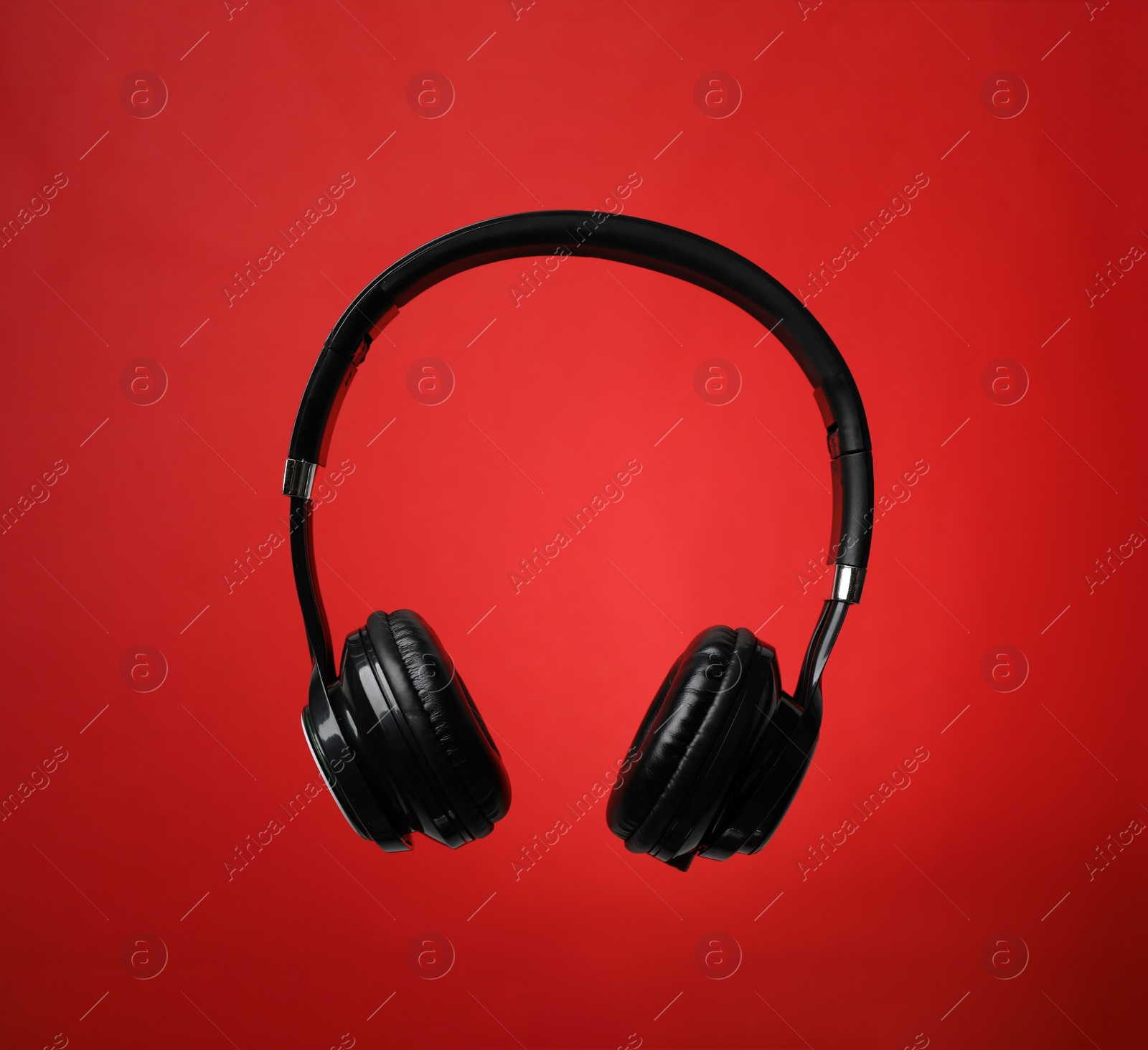 Photo of Stylish modern headphones with earmuffs on color background