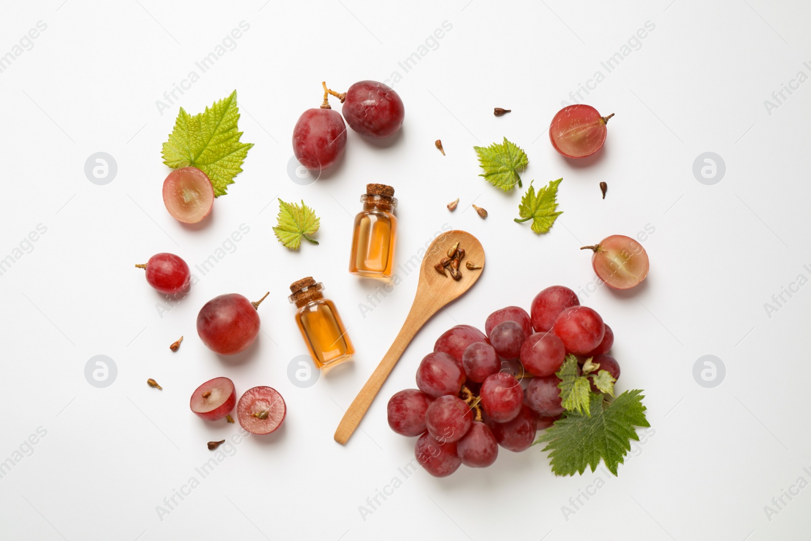 Photo of Composition with bottles of natural grape seed oil on white background, top view. Organic cosmetic