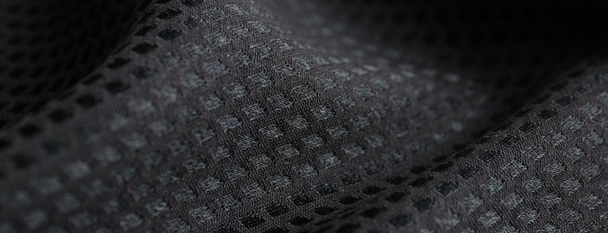Textured black fabric as background, closeup view