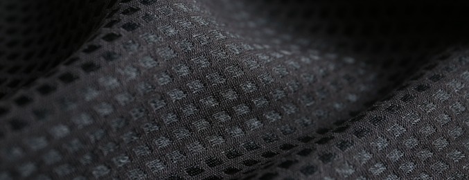 Photo of Textured black fabric as background, closeup view