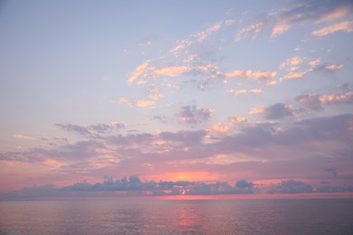 Photo of Picturesque view of sunset with clouds over sea