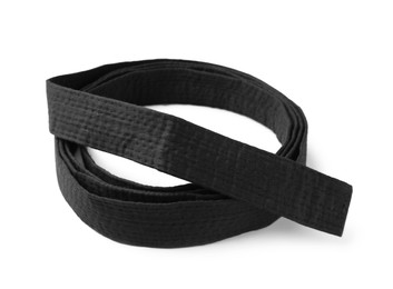 Photo of Rolled black belt on white background. Oriental martial arts