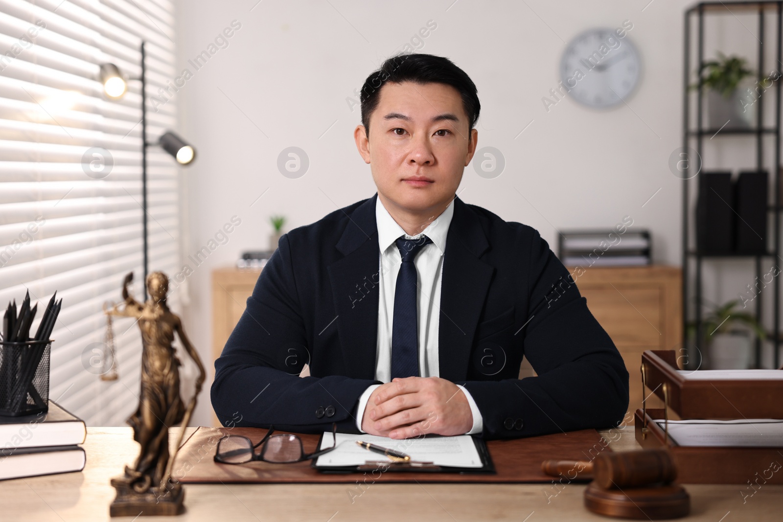 Photo of Notary working at wooden table in office