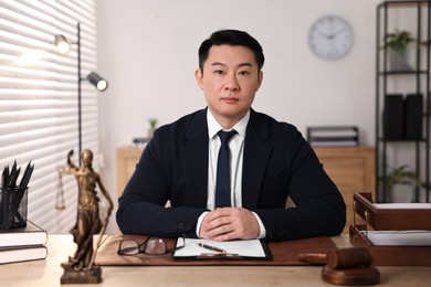 Notary working at wooden table in office