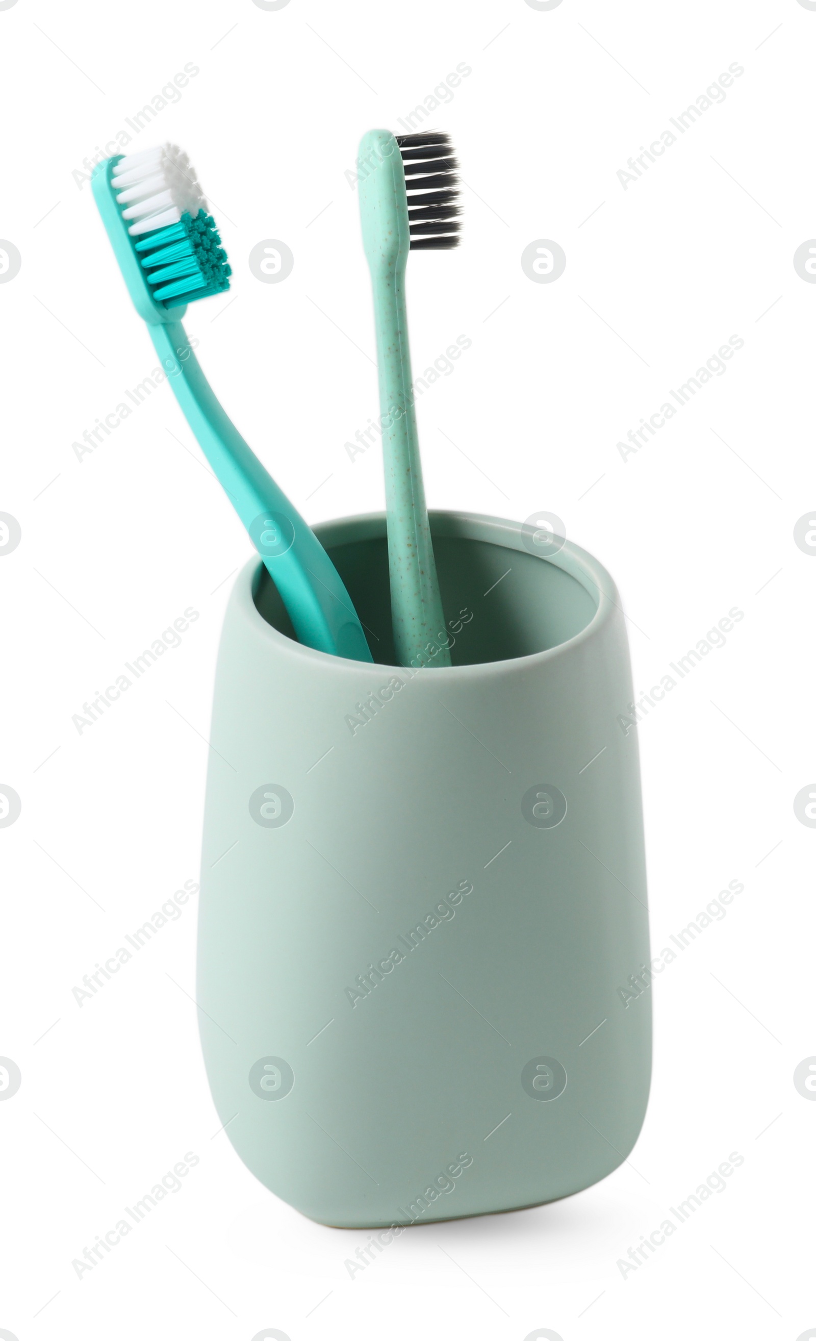 Photo of Bath accessory. Ceramic holder with toothbrushes isolated on white