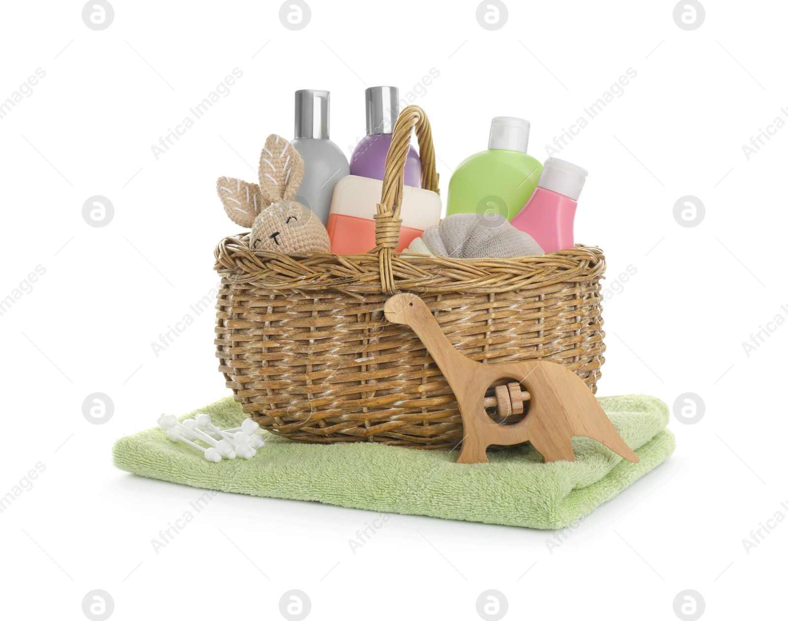 Photo of Wicker basket full of different baby cosmetic products, bathing accessories and toys on white background