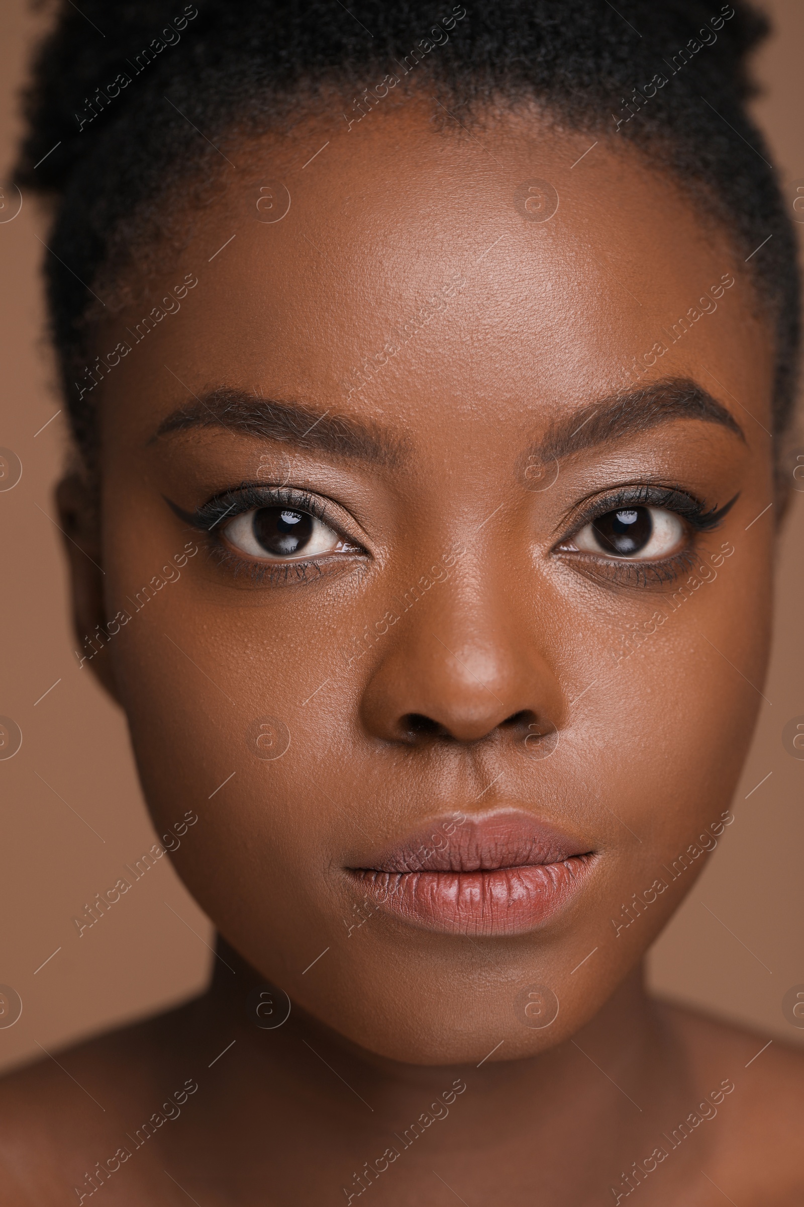 Photo of Portrait of beautiful woman on light brown background, closeup