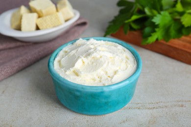 Photo of Delicious tofu cream cheese in bowl on light table, closeup