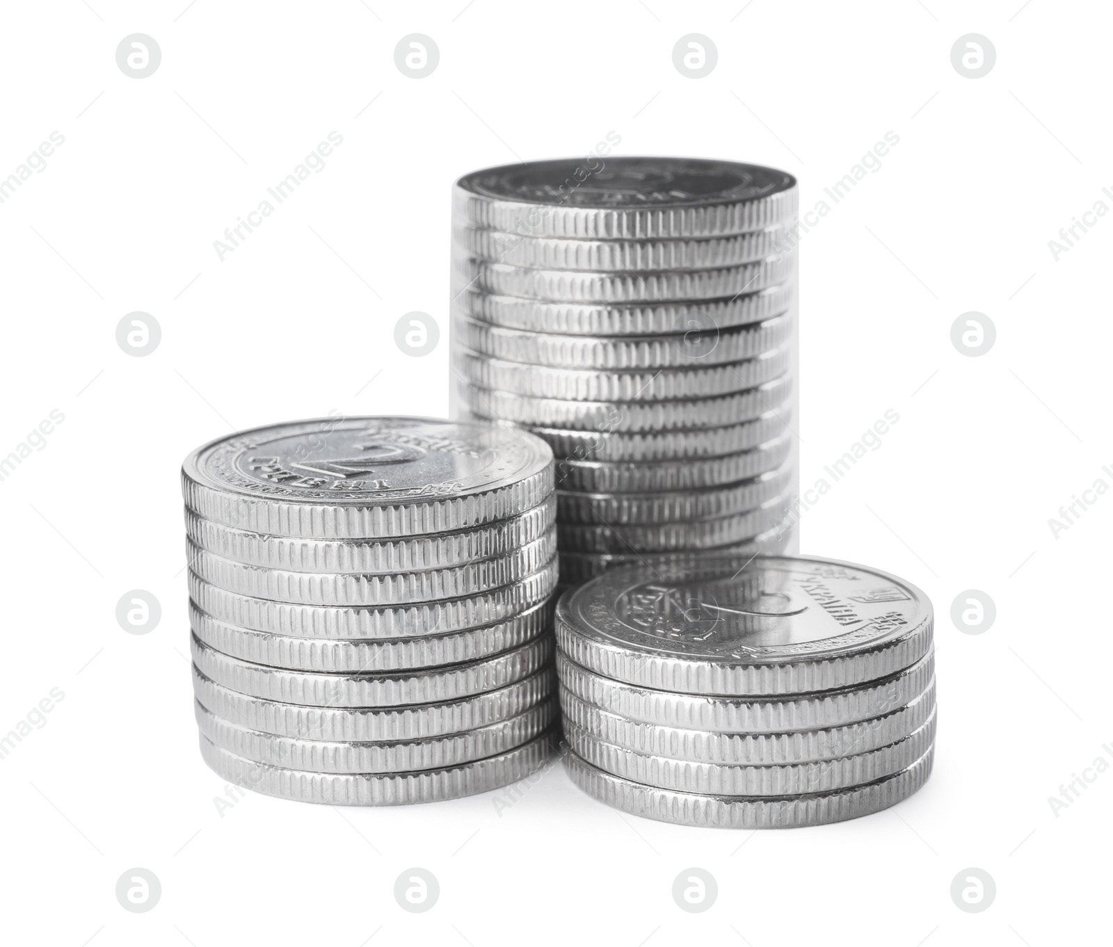 Photo of Stacks of Ukrainian coins on white background. National currency