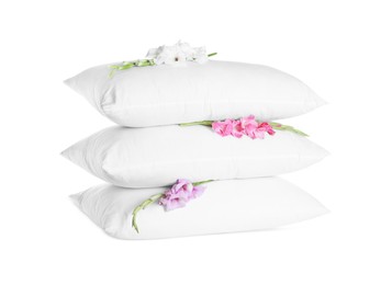 Soft pillows with beautiful flowers on white background