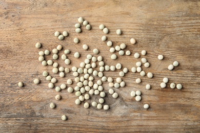 Raw dry peas on wooden background, flat lay. Vegetable seeds