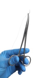 Doctor holding forceps with suture thread on white background, closeup. Medical equipment