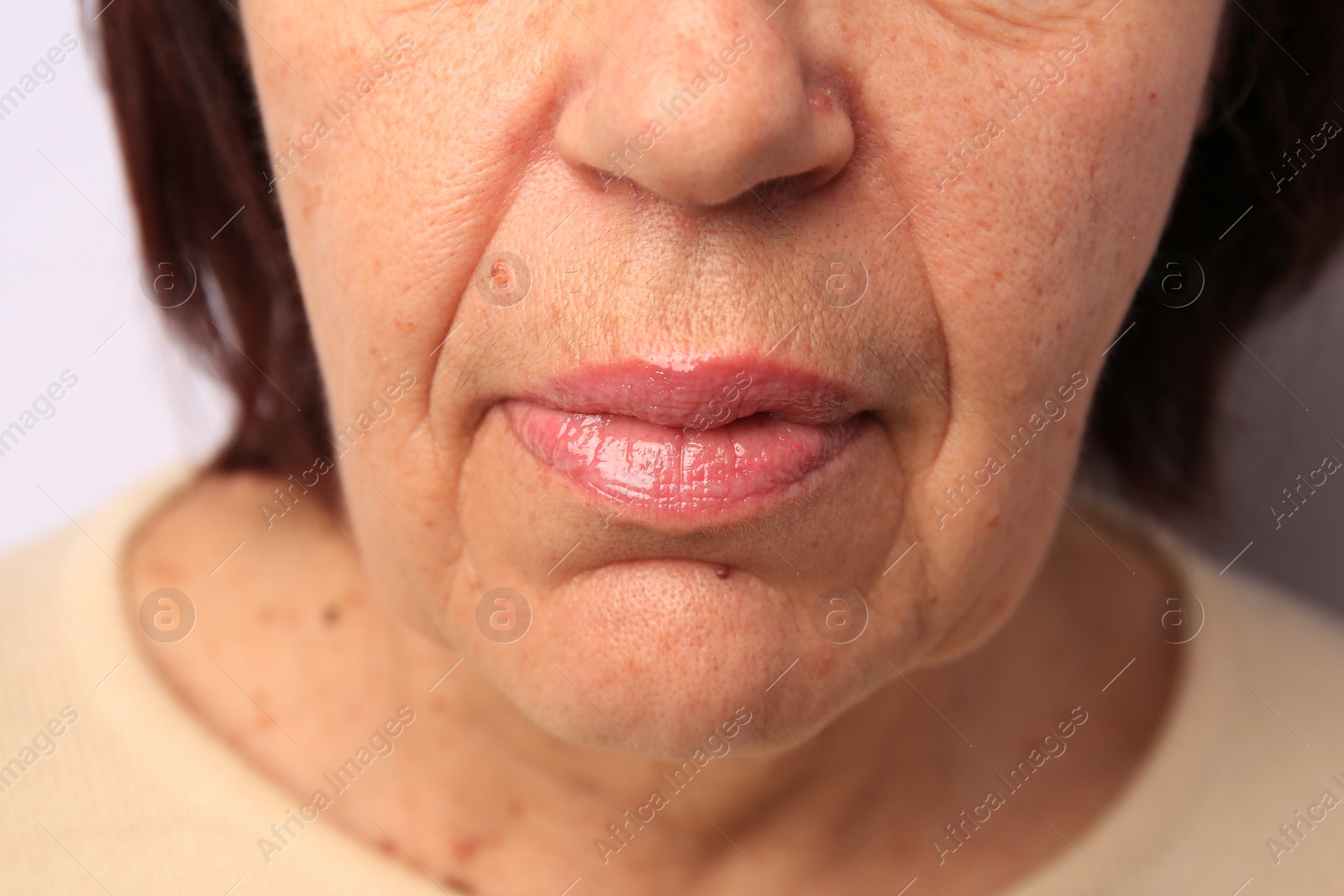 Photo of Closeup view of older woman on white background