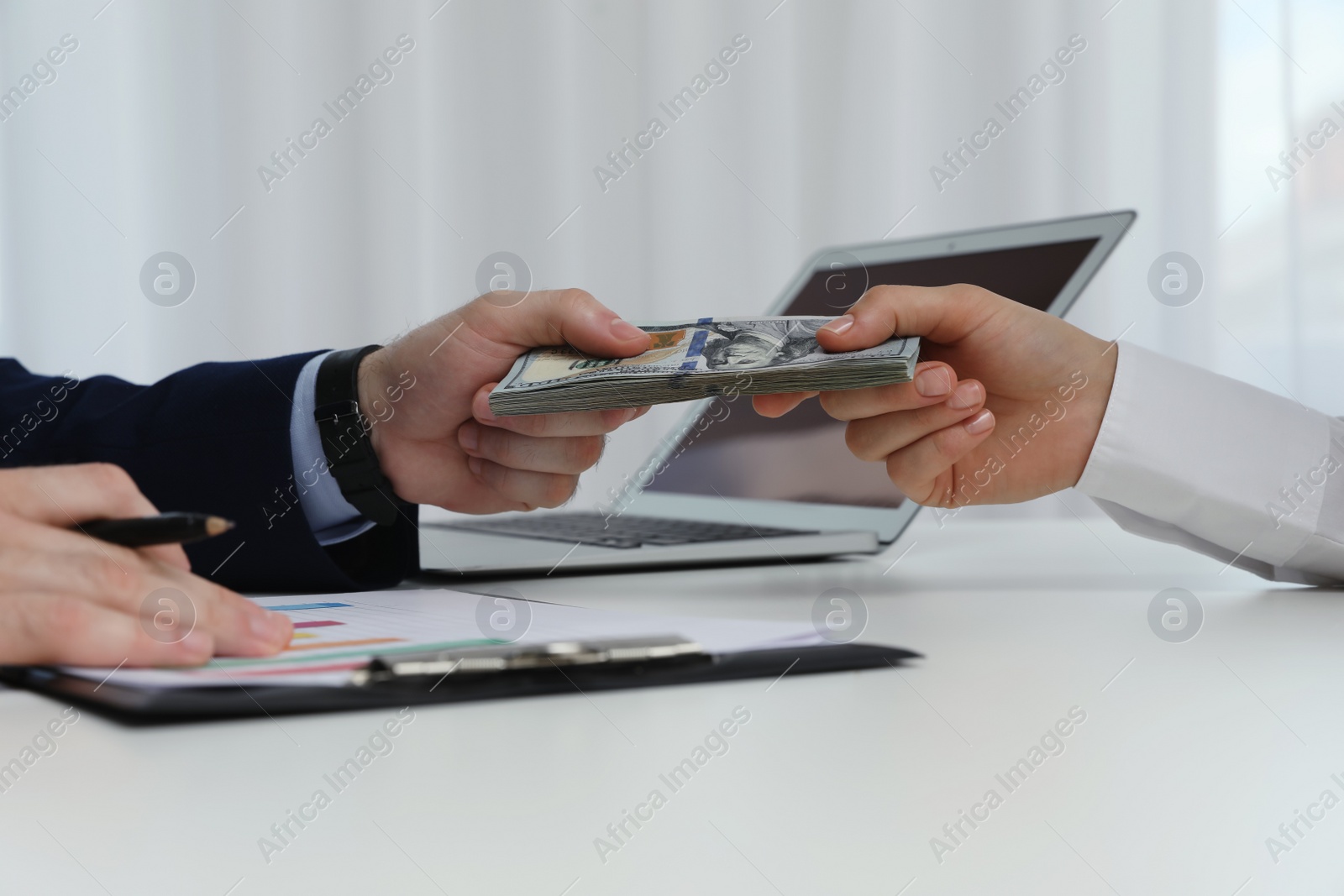 Photo of Cashier giving money to businesswoman at desk in bank, closeup