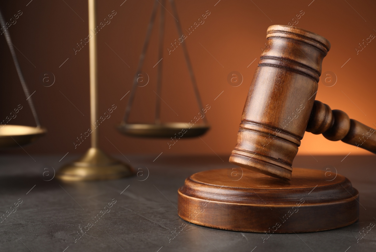 Photo of Wooden gavel on grey table, space for text. Law concept