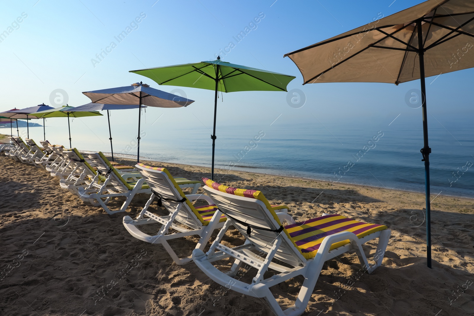 Photo of Many beach umbrellas and sunbeds at resort