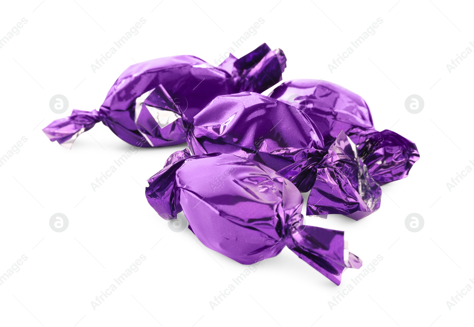Photo of Candies in purple wrappers isolated on white