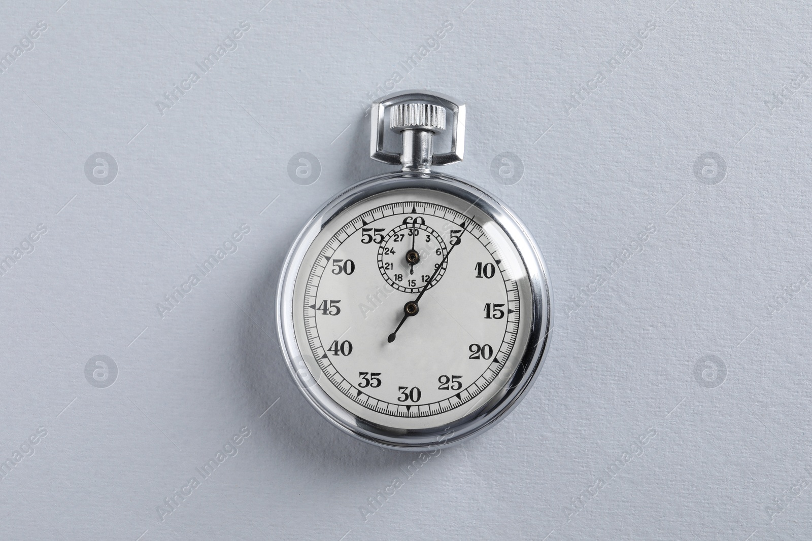 Photo of Vintage timer on light grey background, top view. Measuring tool