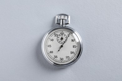 Photo of Vintage timer on light grey background, top view. Measuring tool