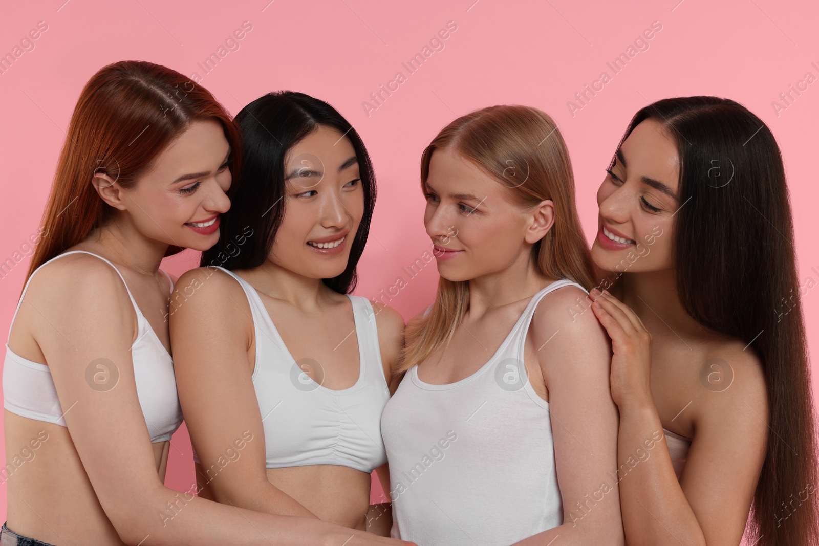 Photo of Portrait of beautiful young women on pink background