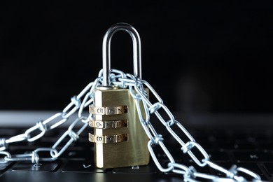 Photo of Cyber security. Padlock with chain on laptop, closeup