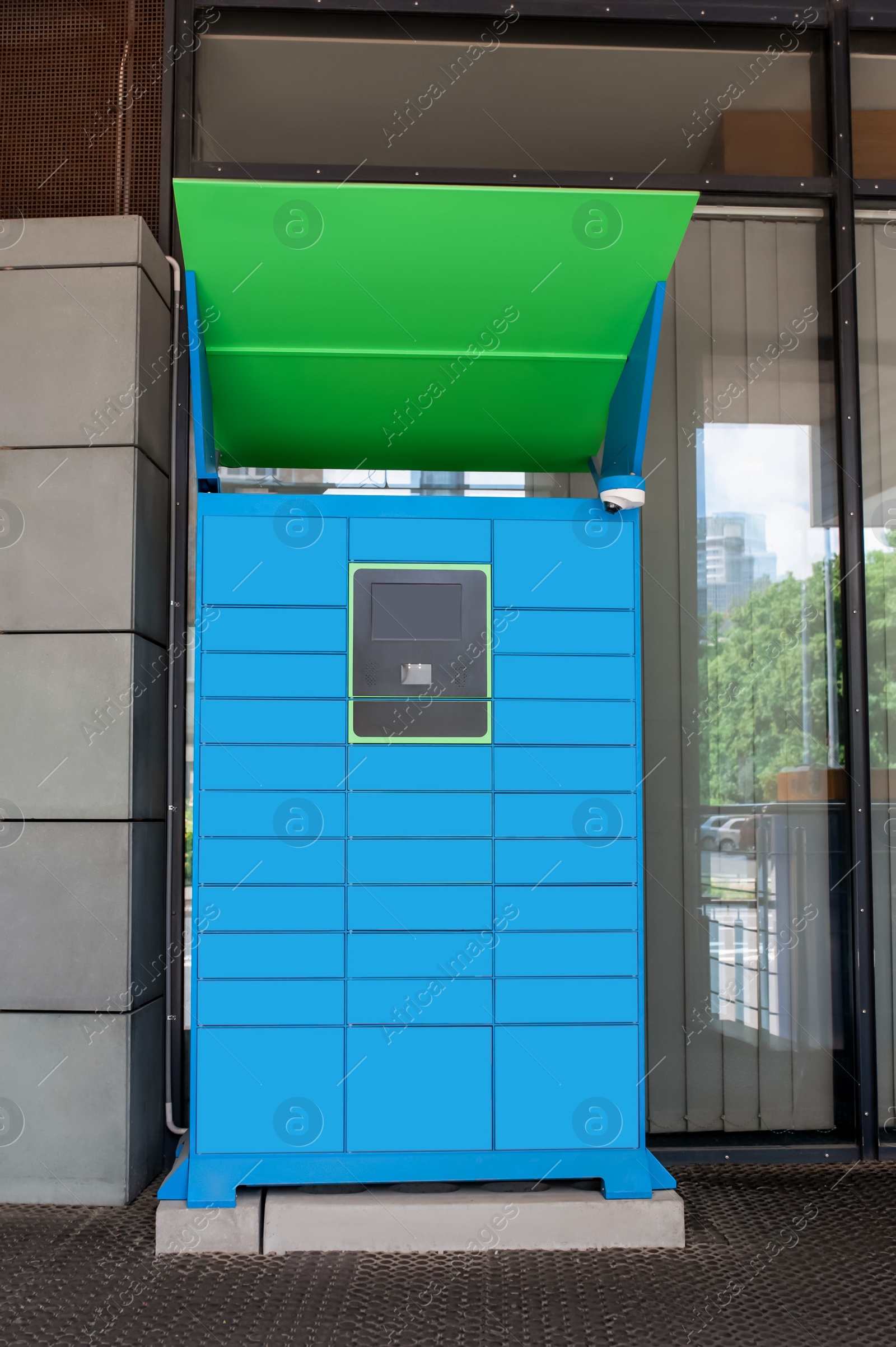 Photo of Parcel locker with many postal boxes near building outdoors