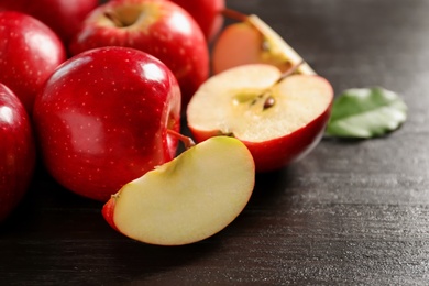 Photo of Fresh ripe red apples on wooden background, closeup