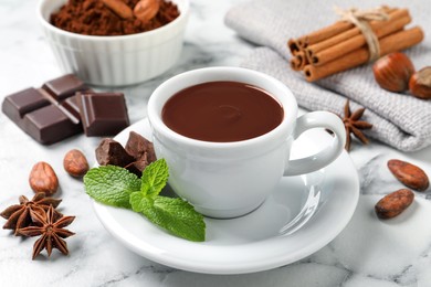 Photo of Composition with yummy hot chocolate in cup on white marble table