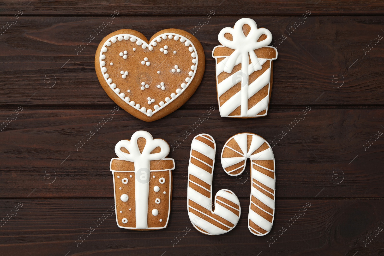 Photo of Different delicious Christmas cookies on wooden table, flat lay