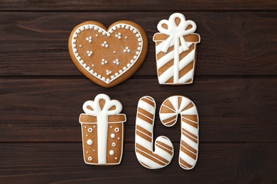 Different delicious Christmas cookies on wooden table, flat lay