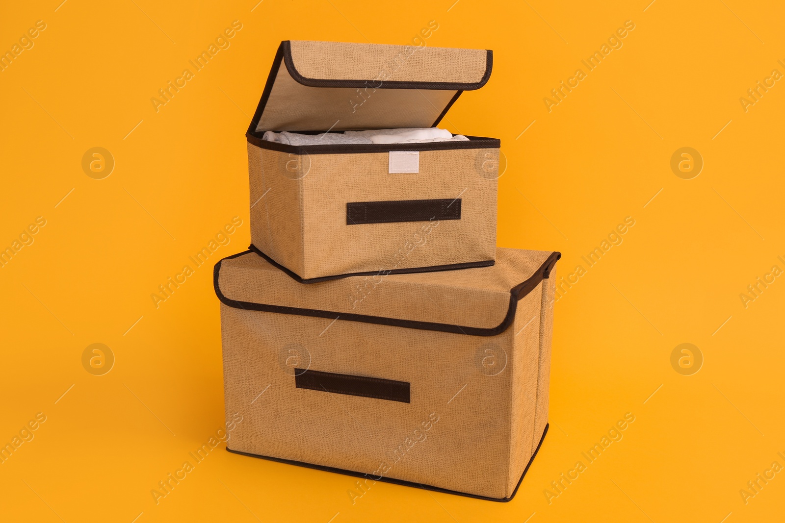 Photo of Two textile storage cases on yellow background