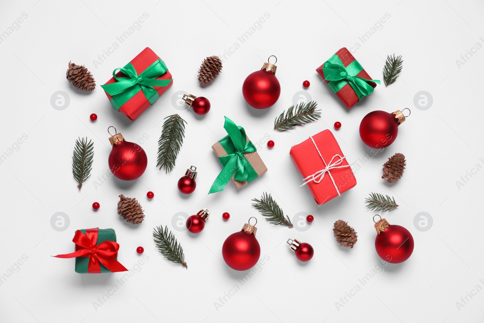 Photo of Flat lay composition with gift boxes and Christmas decor on white background
